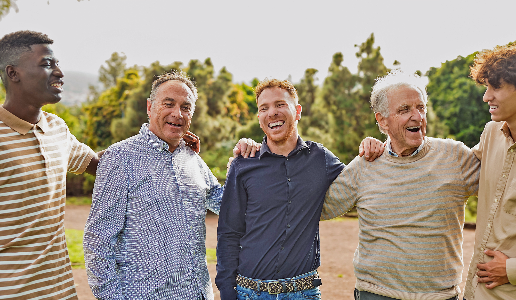 men in a line arm in arm smiling