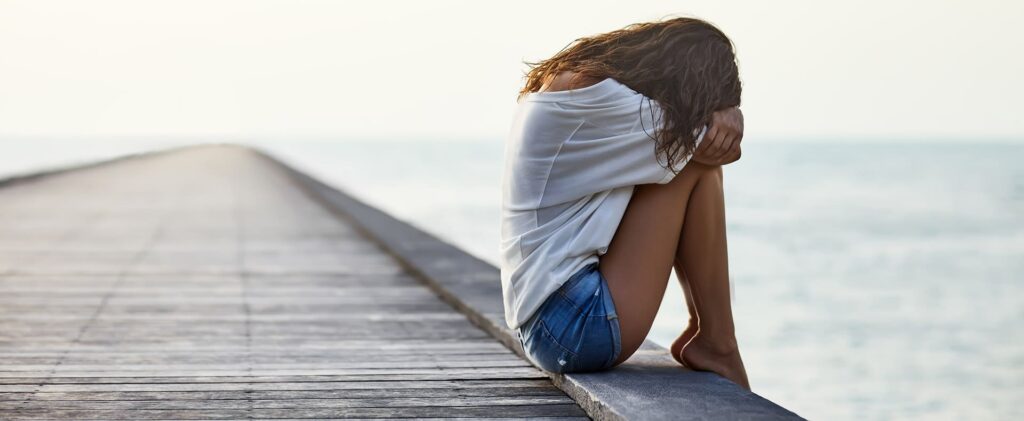 Woman Sitting on Pier